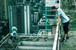 Traceur looking across a dense city skyline from a rooftop